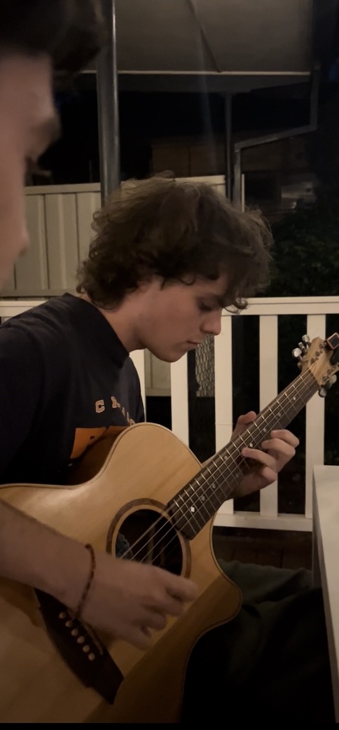 Ned plays guitar, guitarist in Melbourne